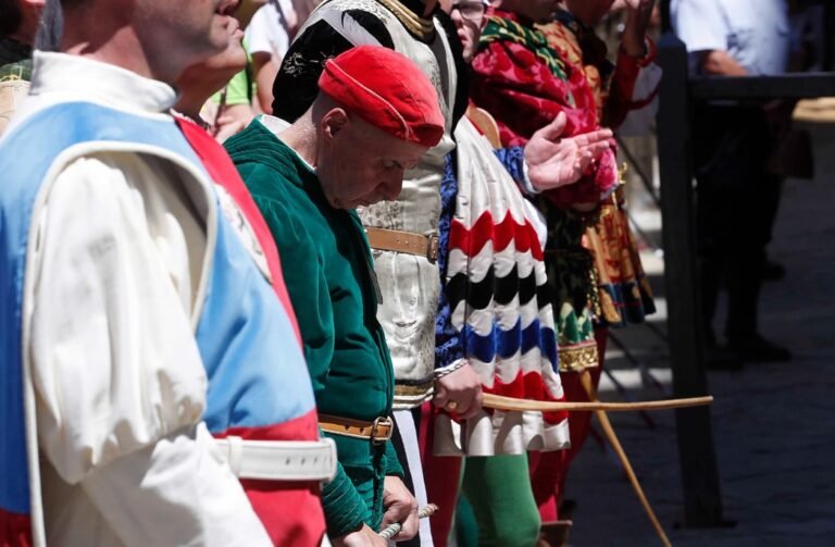 Sienese men in traditional Contrada costumes during the Palio di Siena, showing devotion, pride, and civic identity.